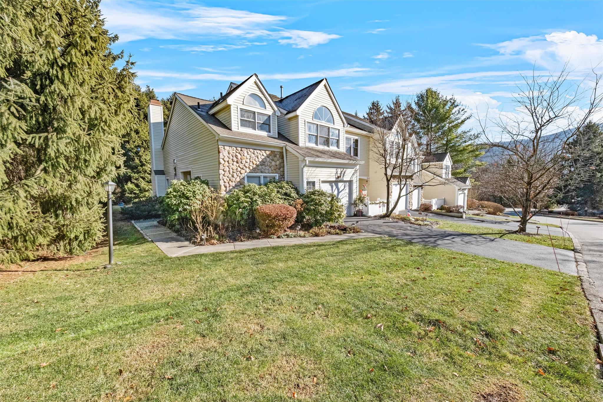 View of front of property with a front yard and a garage