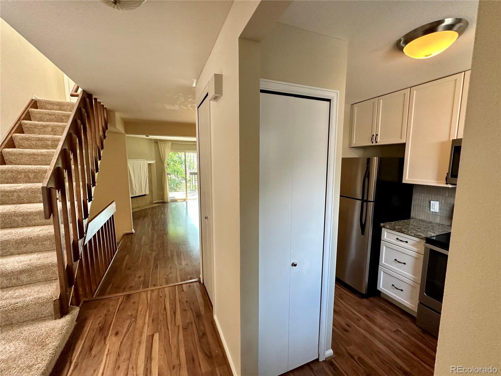 a view of walk in closet with wooden floor and fan