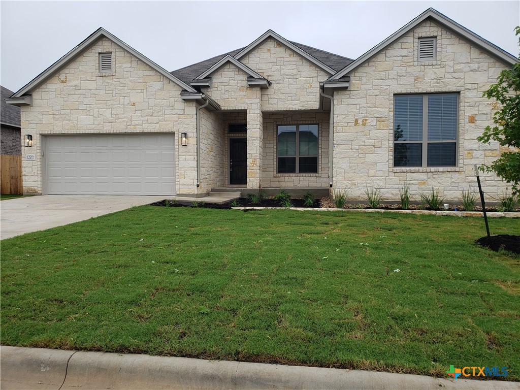 a front view of a house with a yard