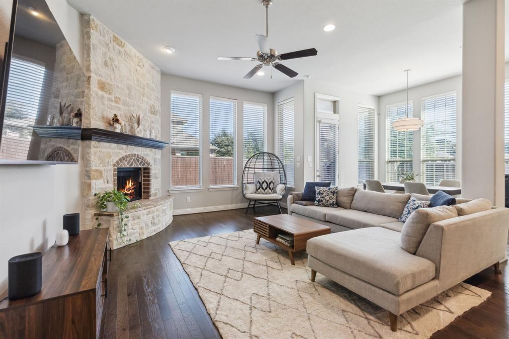 a living room with furniture fireplace and a large window