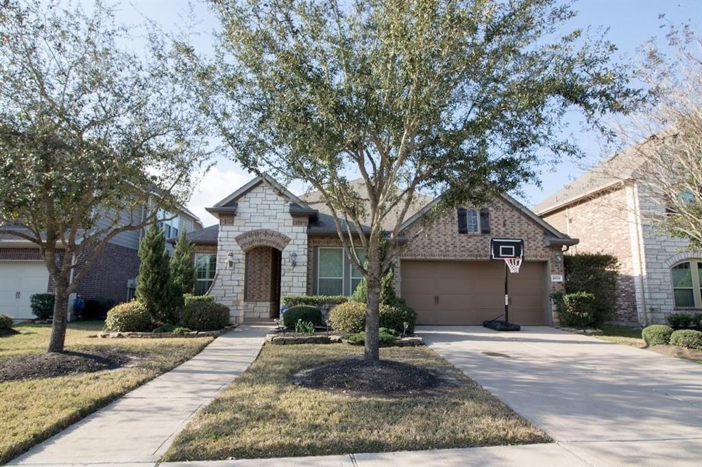 a front view of a house with yard and garage