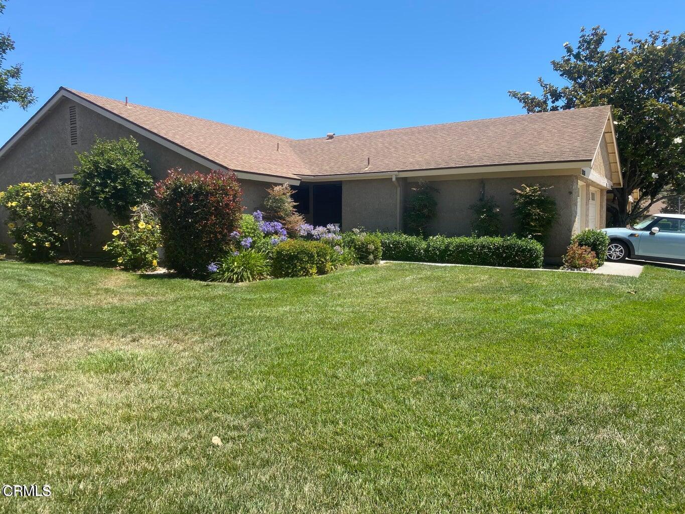 a view of a house with garden and yard