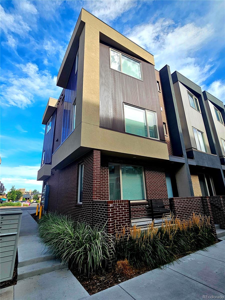 a front view of house along with deck and outdoor seating