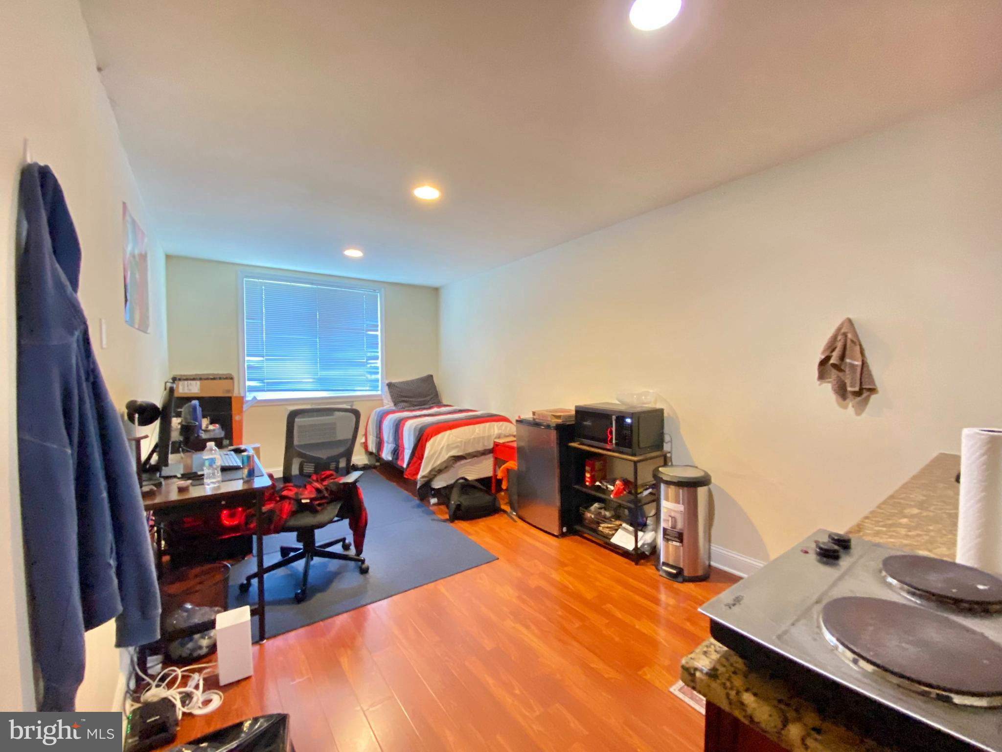 a bed room with furniture and a flat screen tv