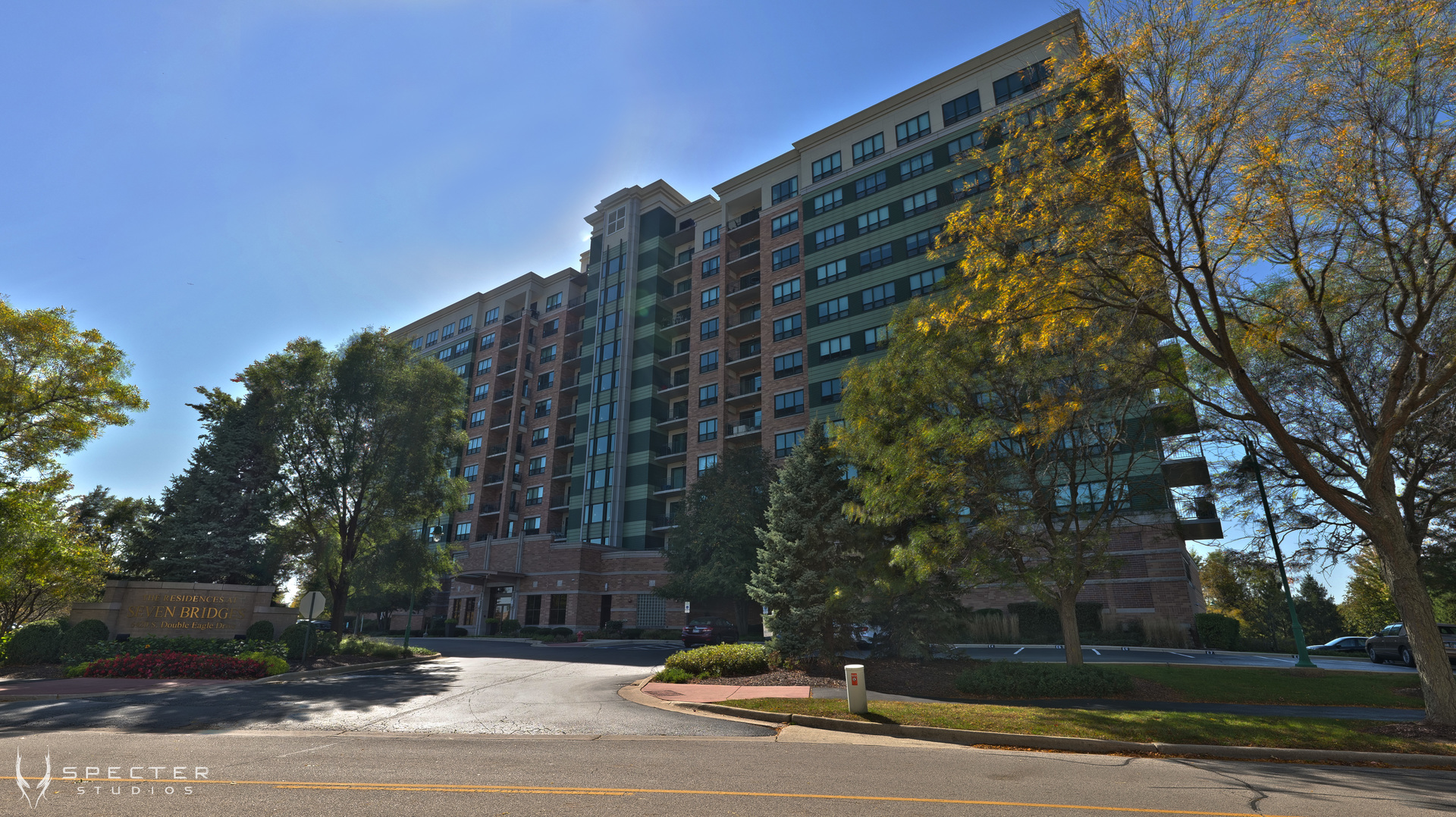 a view of a tall building next to a road