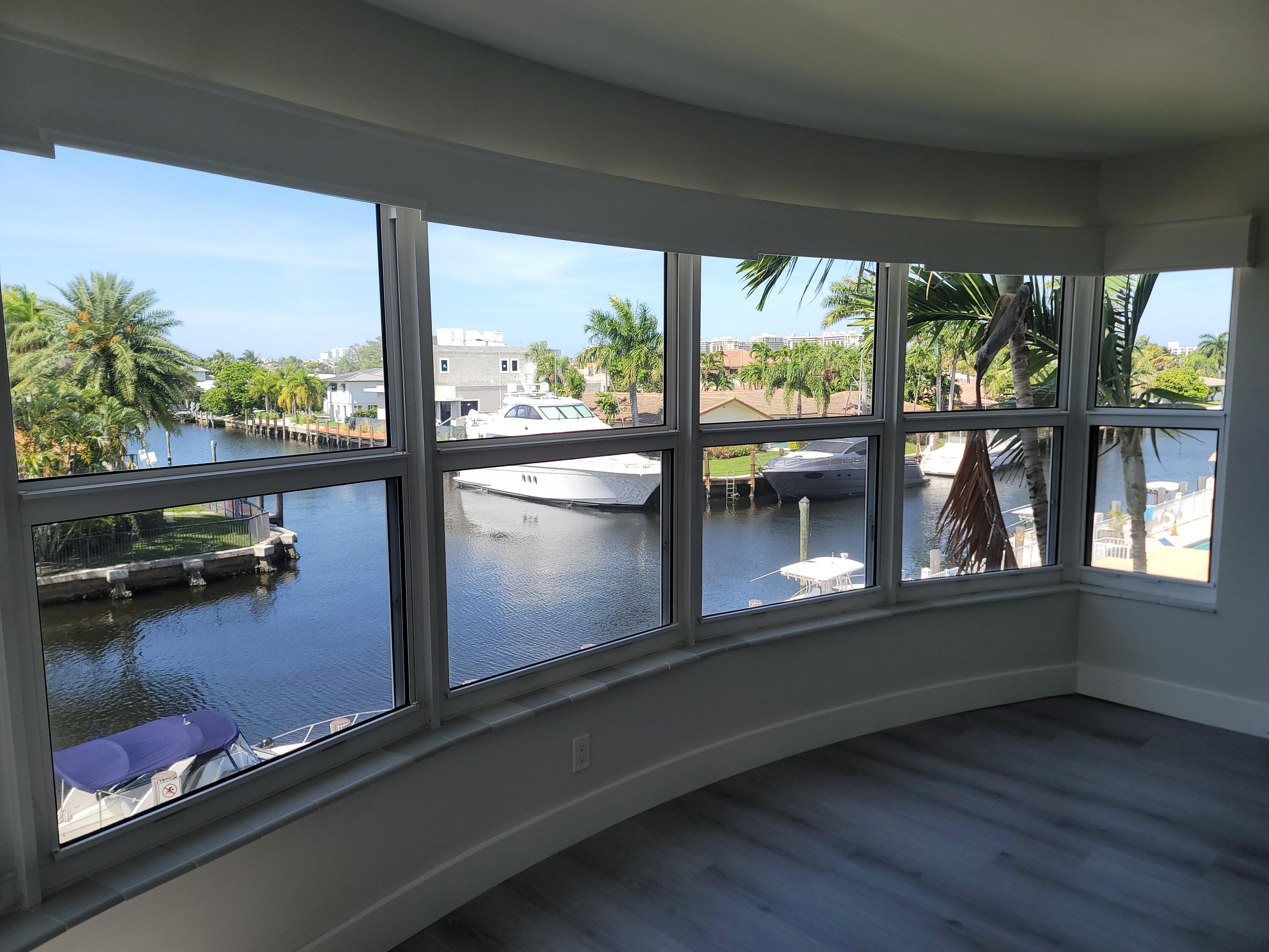 a view of a living room and floor to ceiling window and wooden floor