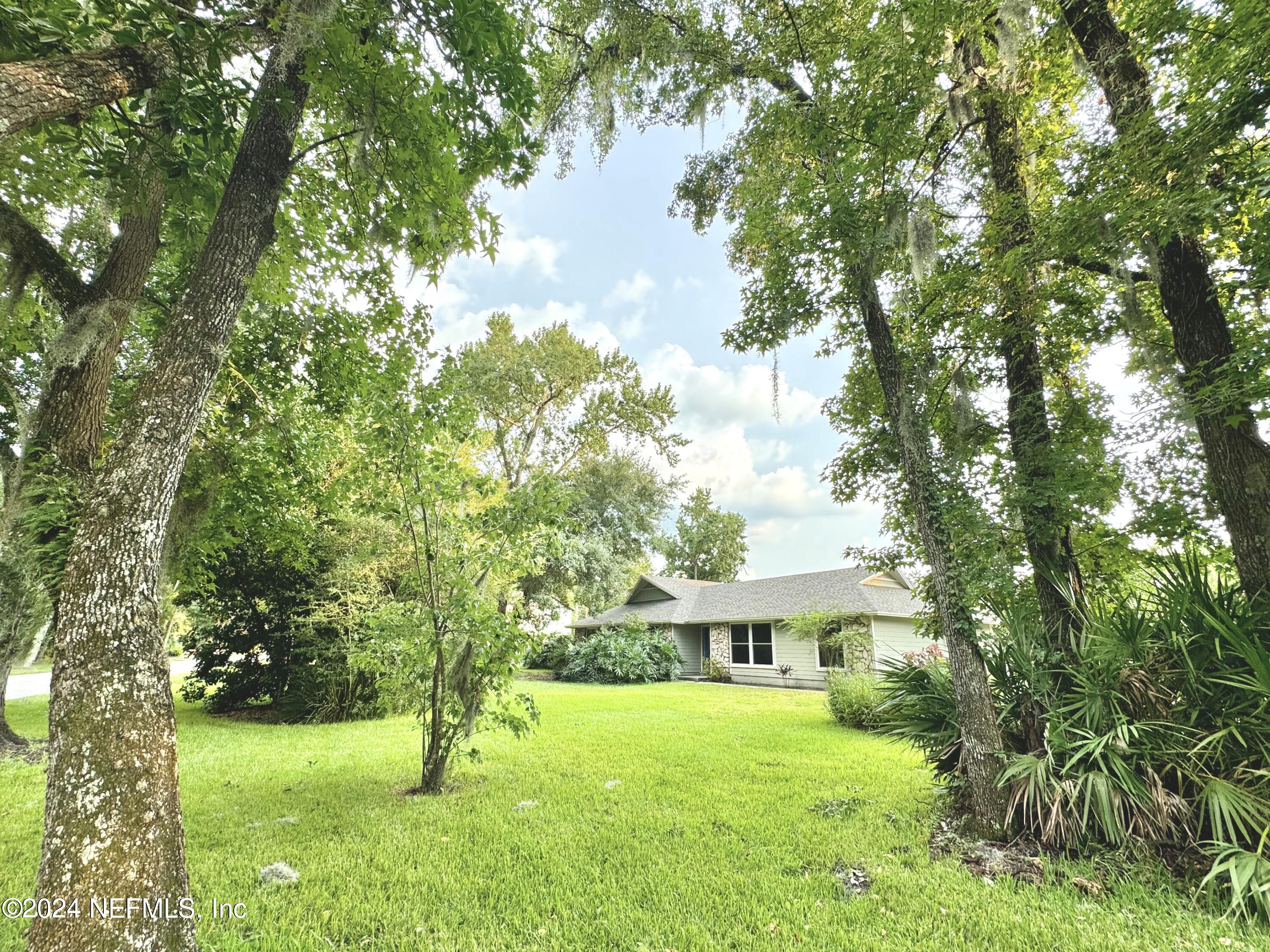 a view of house with yard