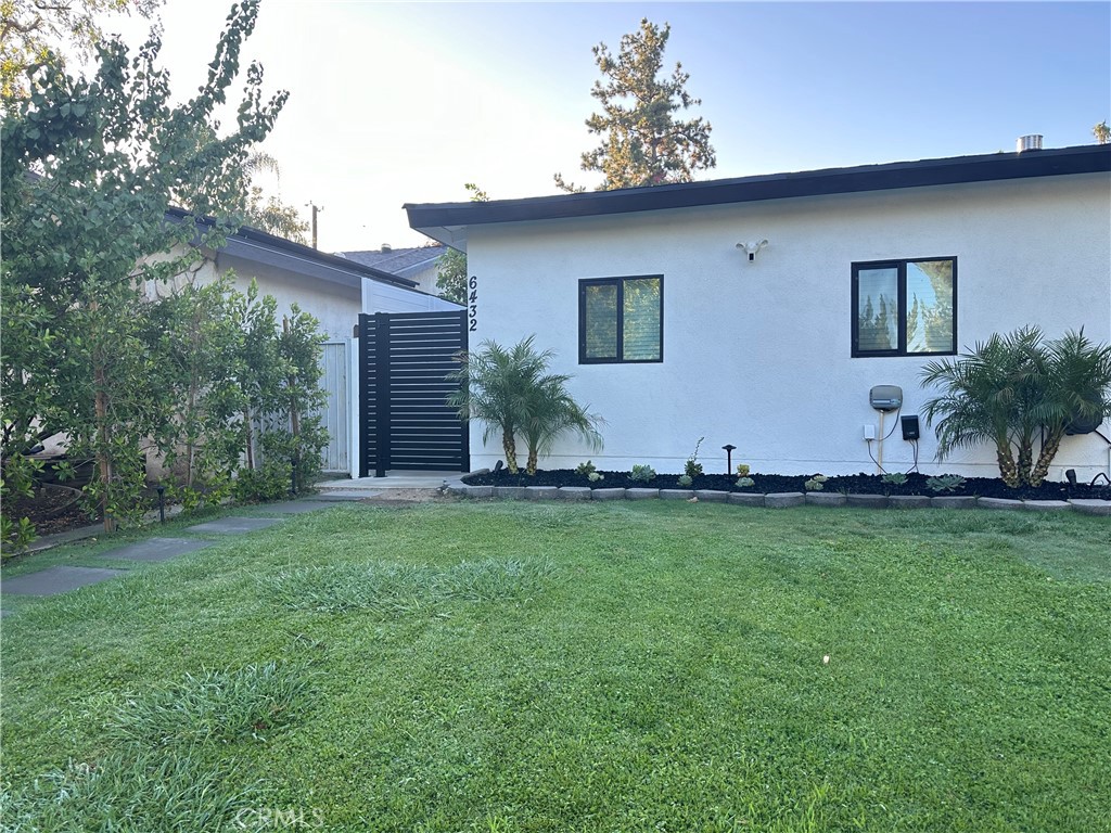 a front view of house with yard and outdoor seating