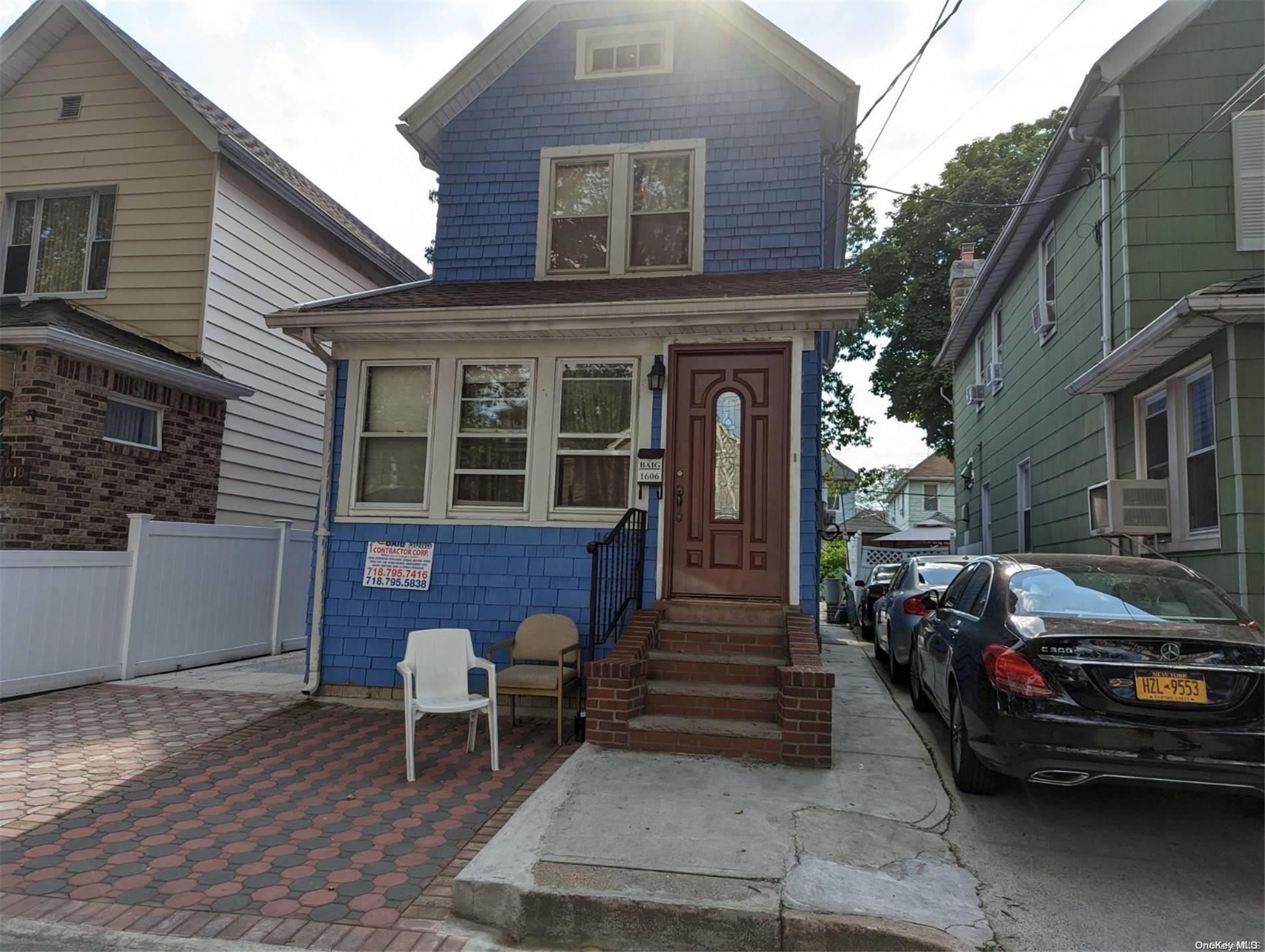 a couple of cars parked in front of a house