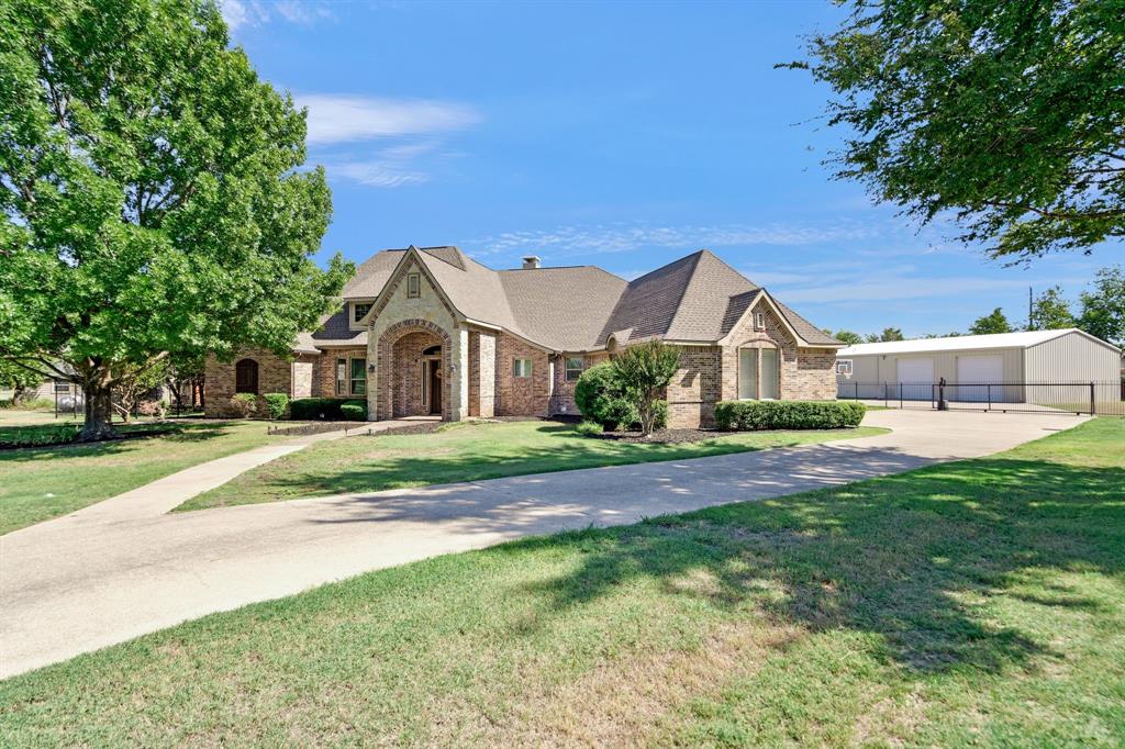 a front view of house with yard and green space