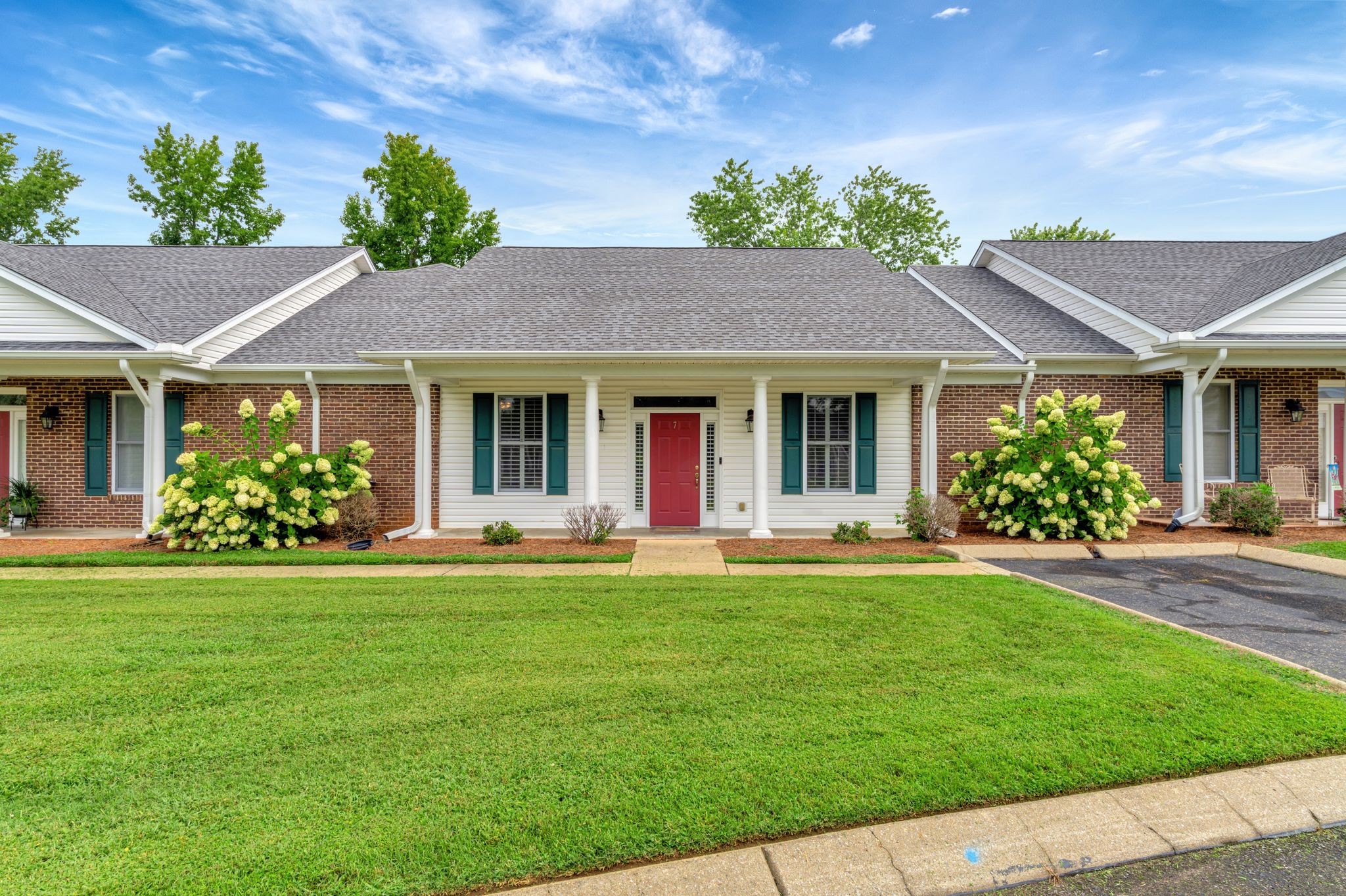 a front view of a house with a garden