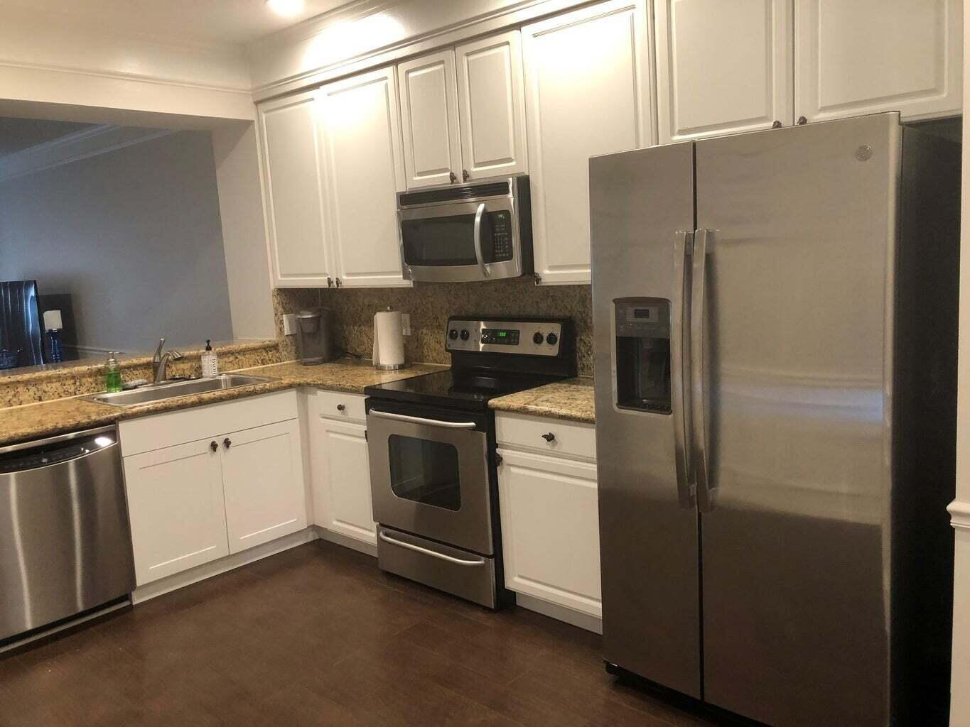 a kitchen with a refrigerator sink and microwave