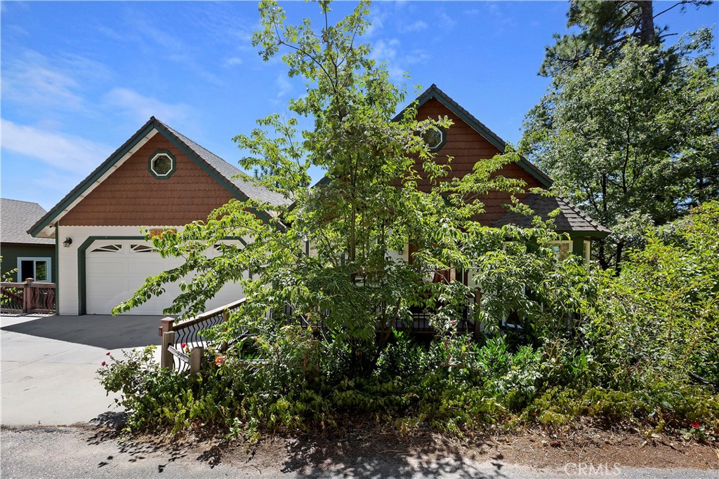 a view of a house with a tree