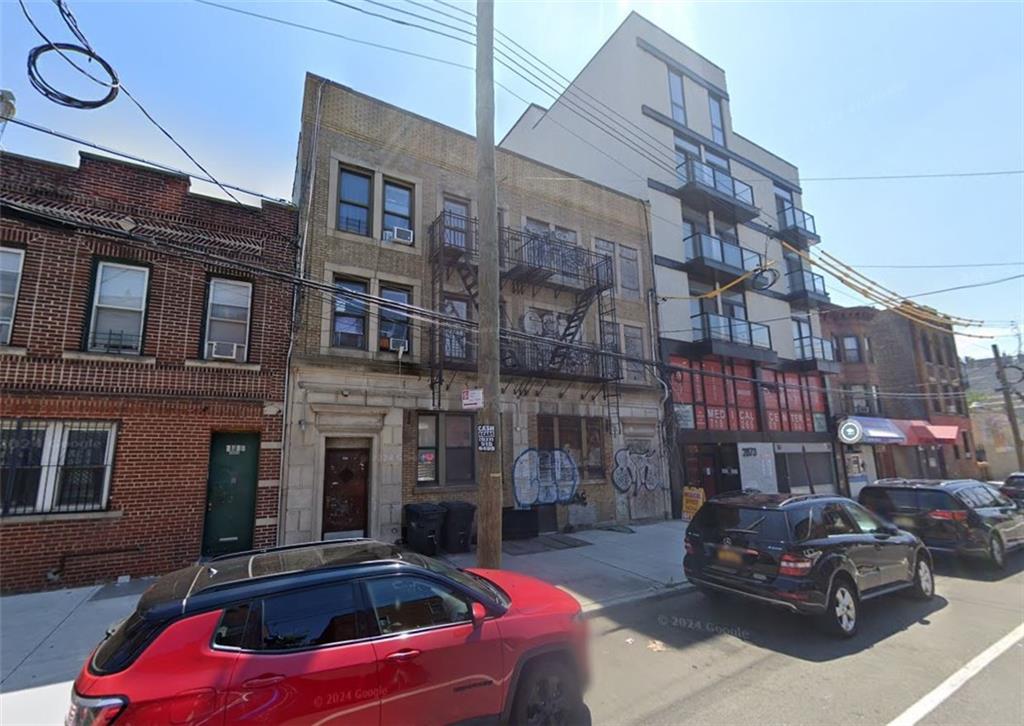 a car parked in front of a brick building