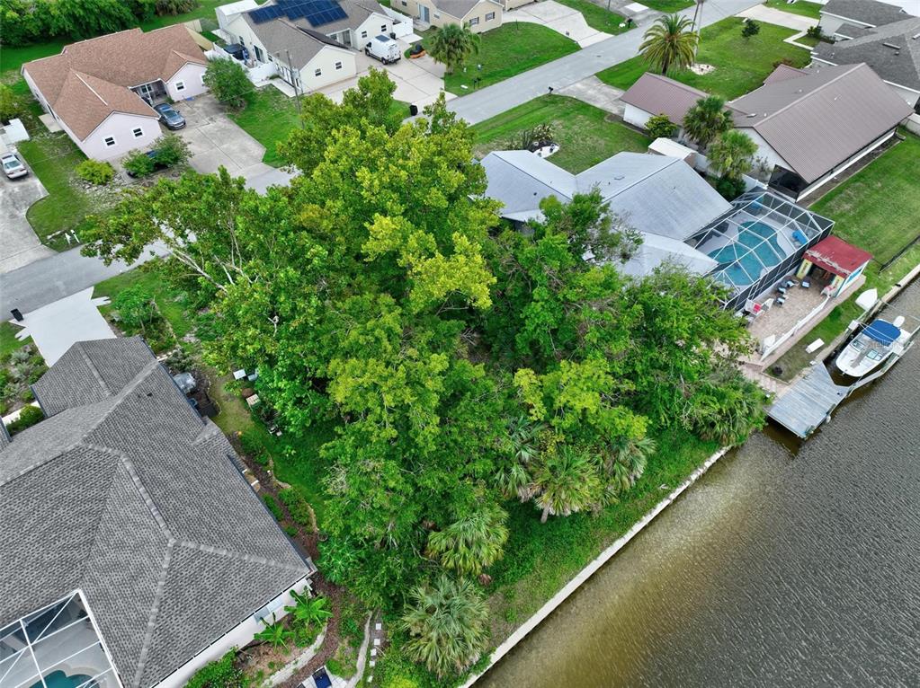 an aerial view of a house with garden space and street view