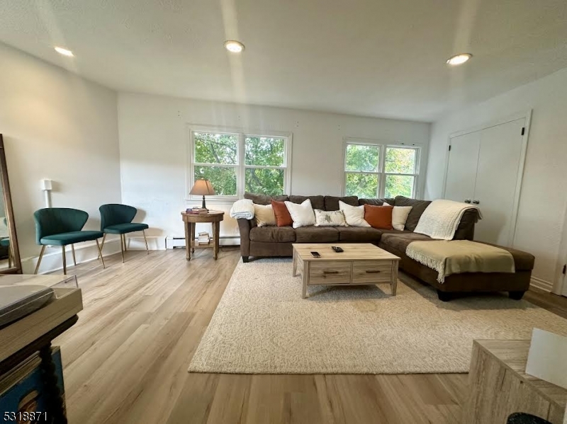 a living room with furniture and a large window