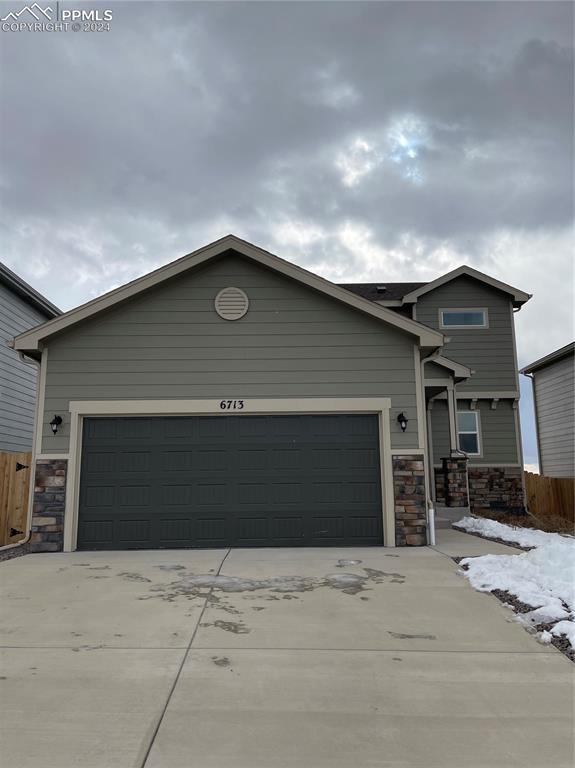 View of front of property featuring a garage