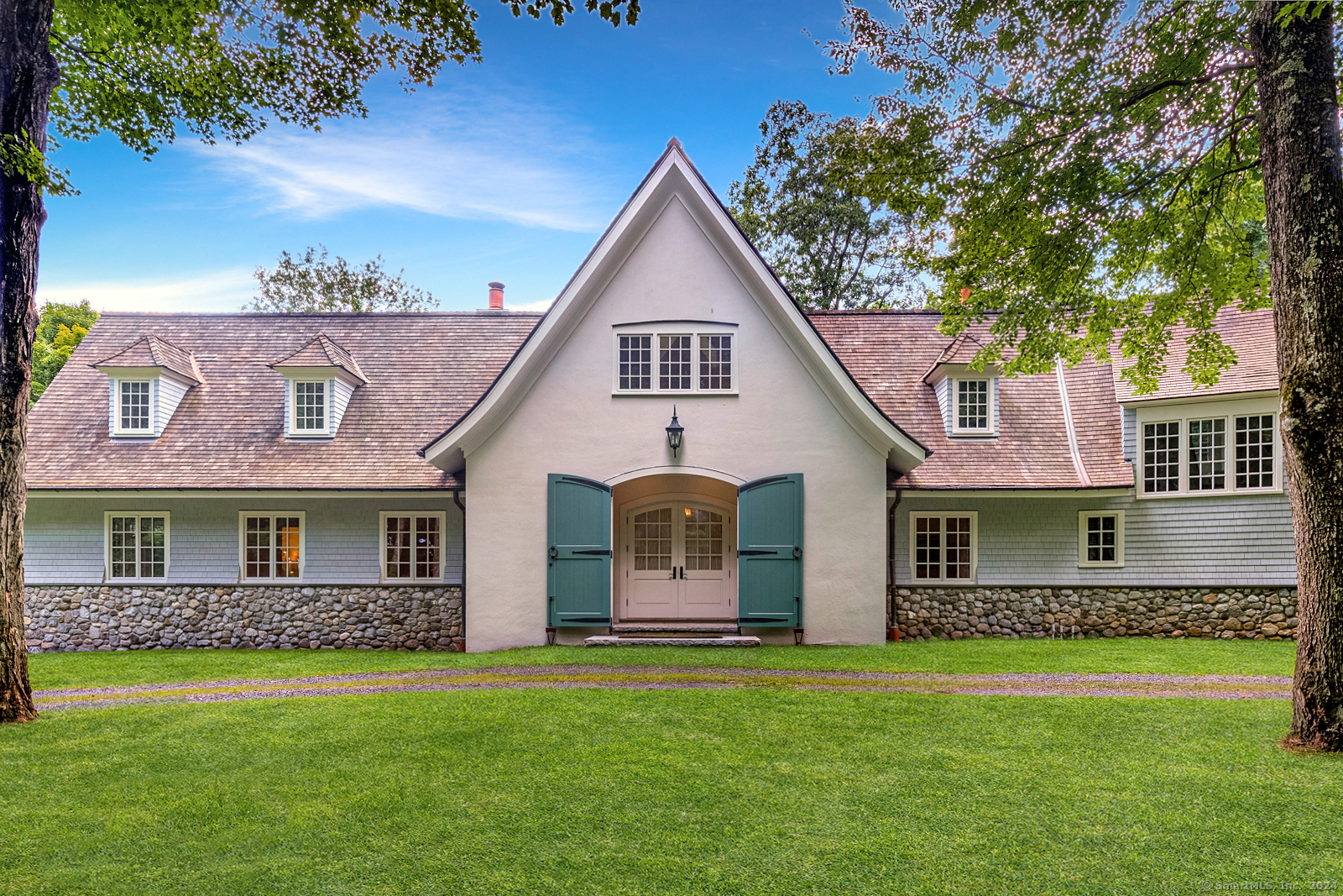 a front view of a house with a garden