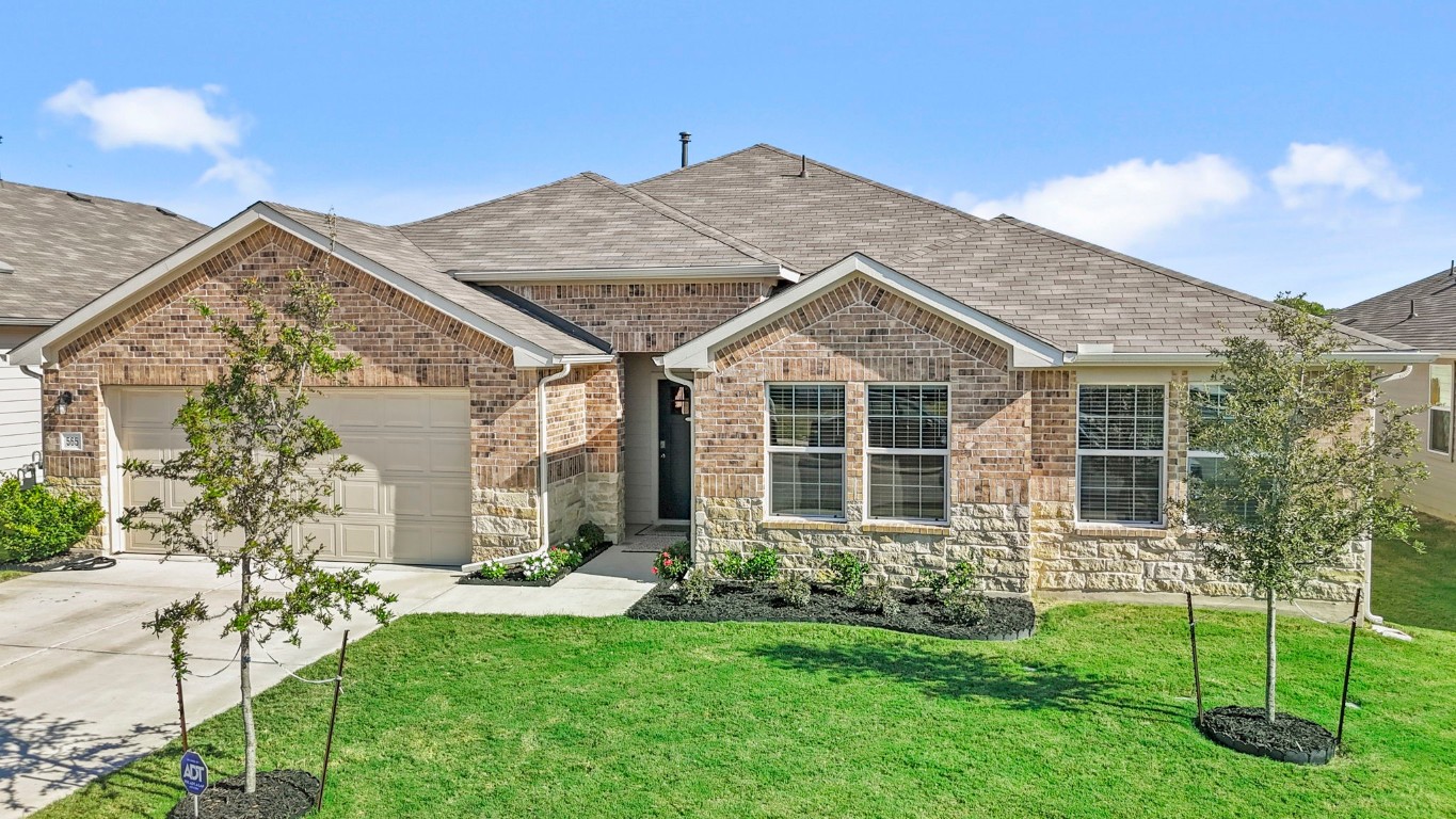 a view of a house with a yard