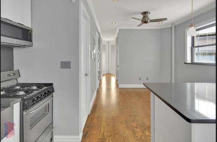 a view of a kitchen with furniture and wooden floor