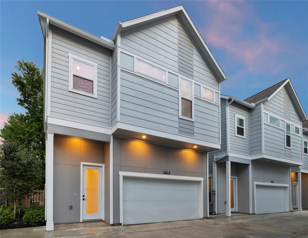 a view of a house with a backyard and a garage