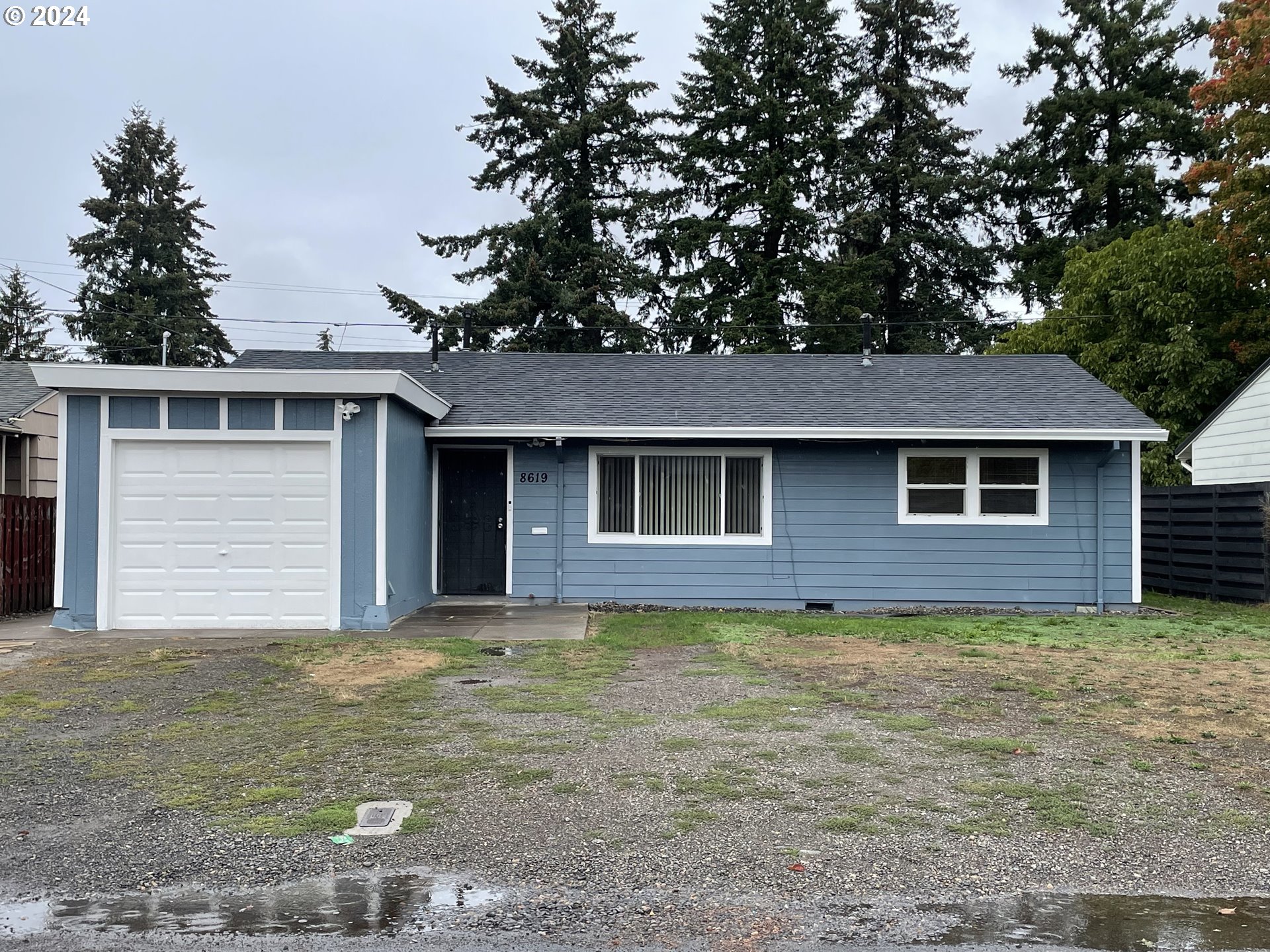 a view of a house with a yard and garage