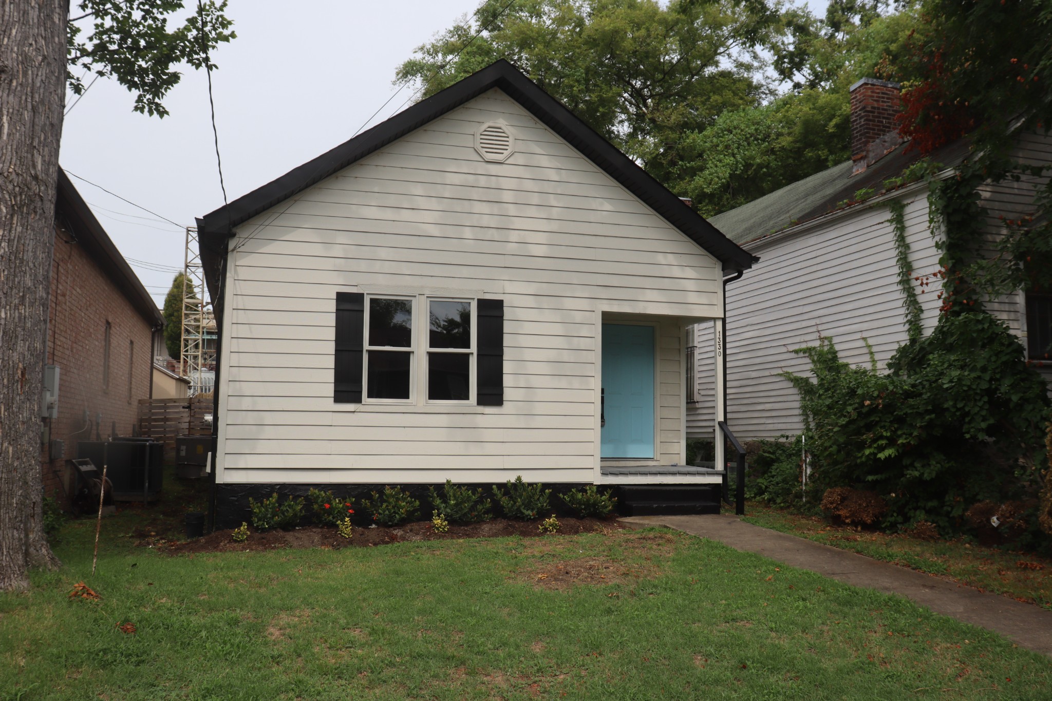 a front view of a house with a garden