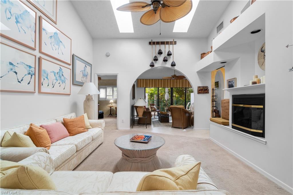 a living room with furniture chandelier and a fireplace