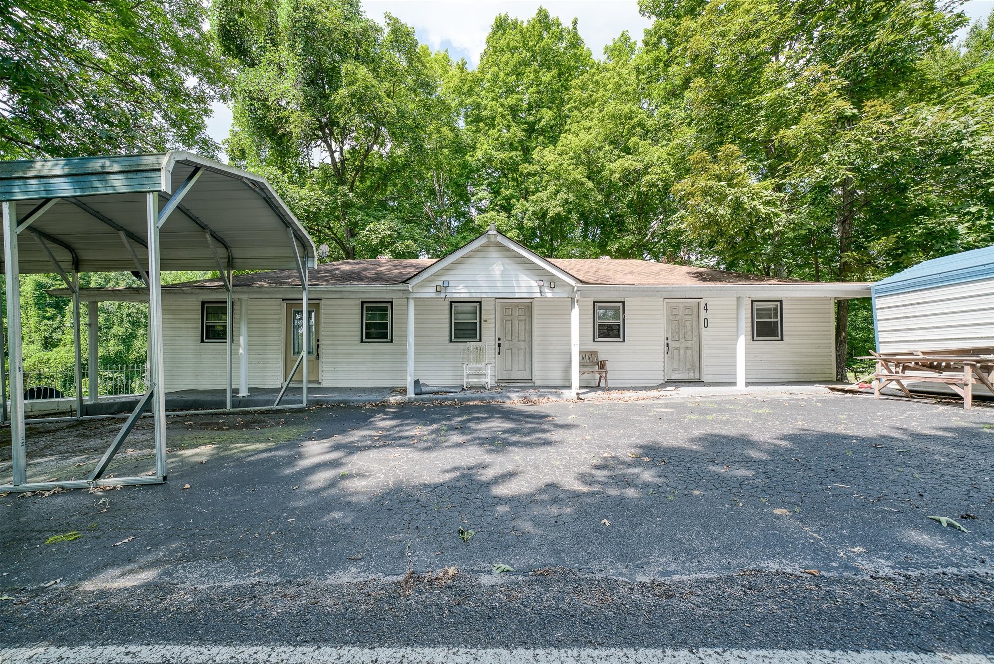 a view of a house with a yard and sitting area