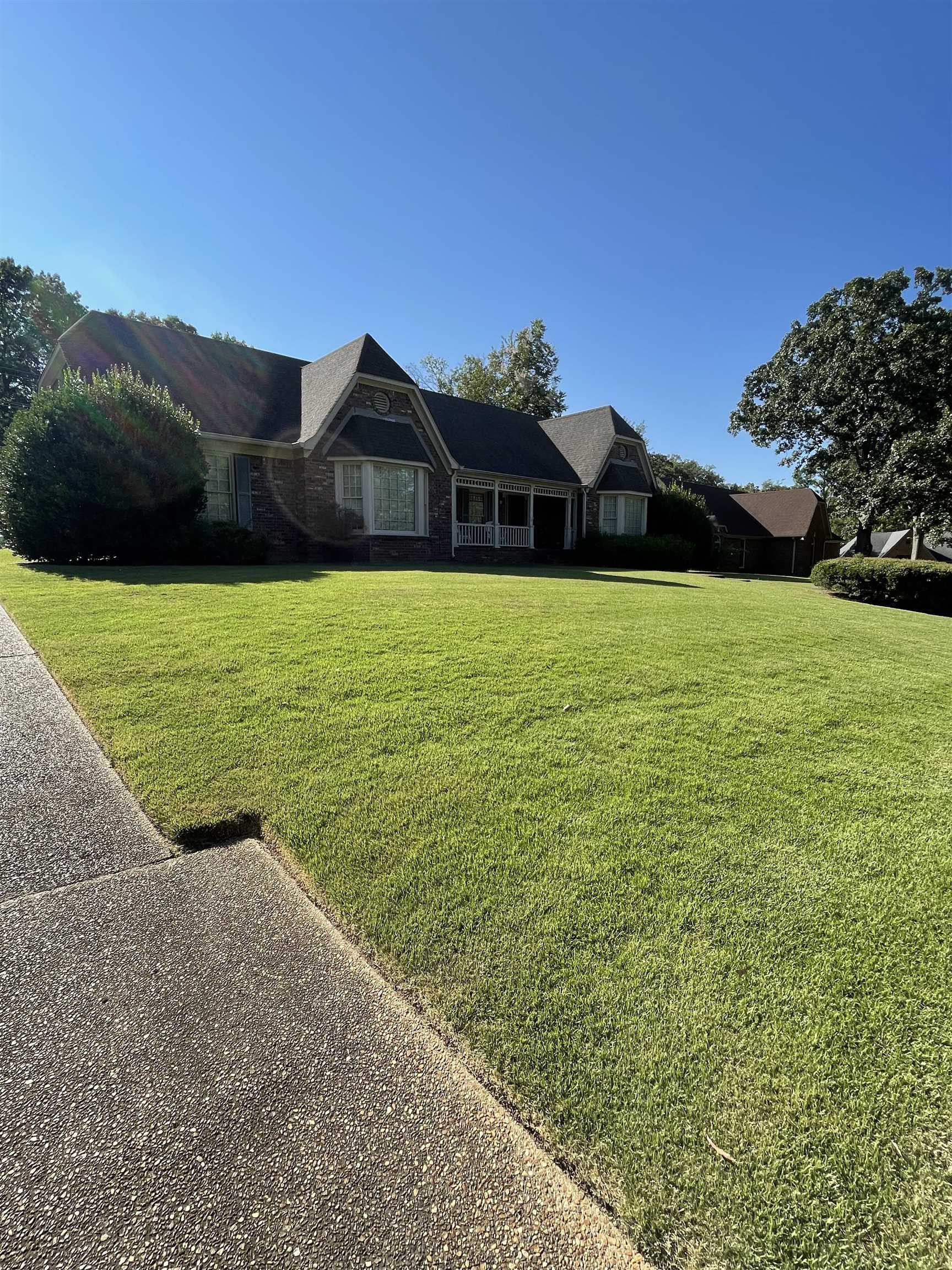 a view of a big house with a big yard