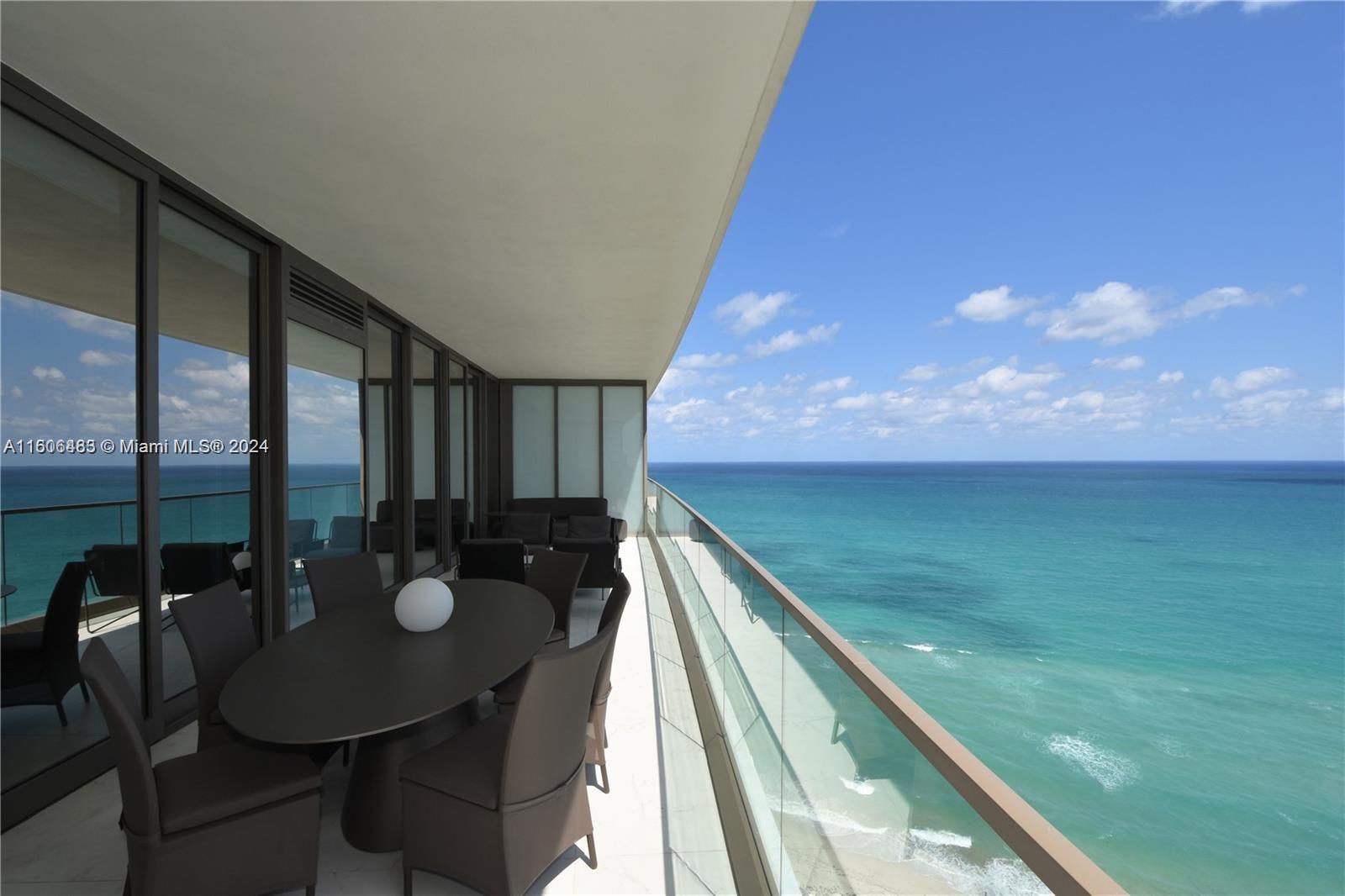 a view of a balcony with a dining table and chairs with wooden floor