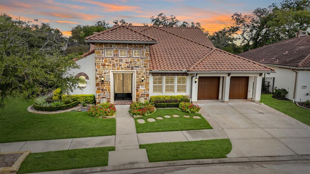 Reminiscent of old world charm, this gorgeous Darling Home situated on an oversized wooded corner lot features a stucco exterior with stone & brick accents surrounded by professional landscaping including stone-lined flower beds serviced by an automatic sprinkler system. The double-wide driveway leads to the home's 3-car attached garage illuminated by coach lantern lighting accentuated by wood-stained overhead doors and decorative corbels. Included is a whole home generator!