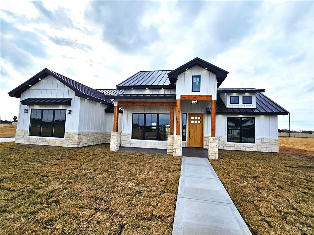 Modern farmhouse style home featuring a yard