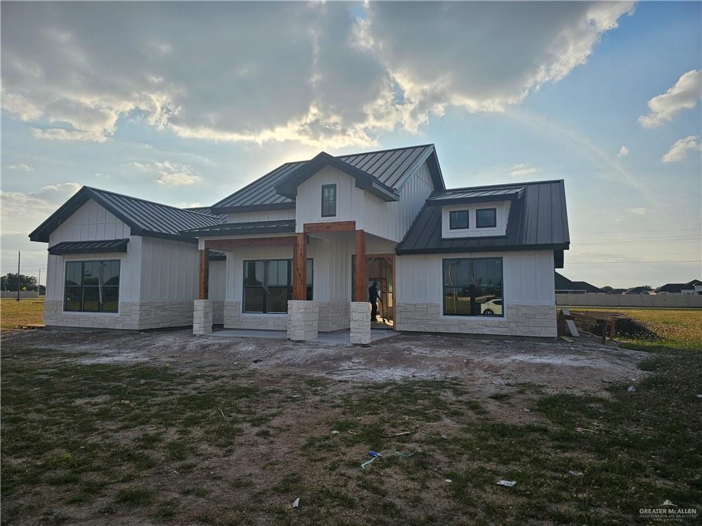 a front view of a house with a garden and yard