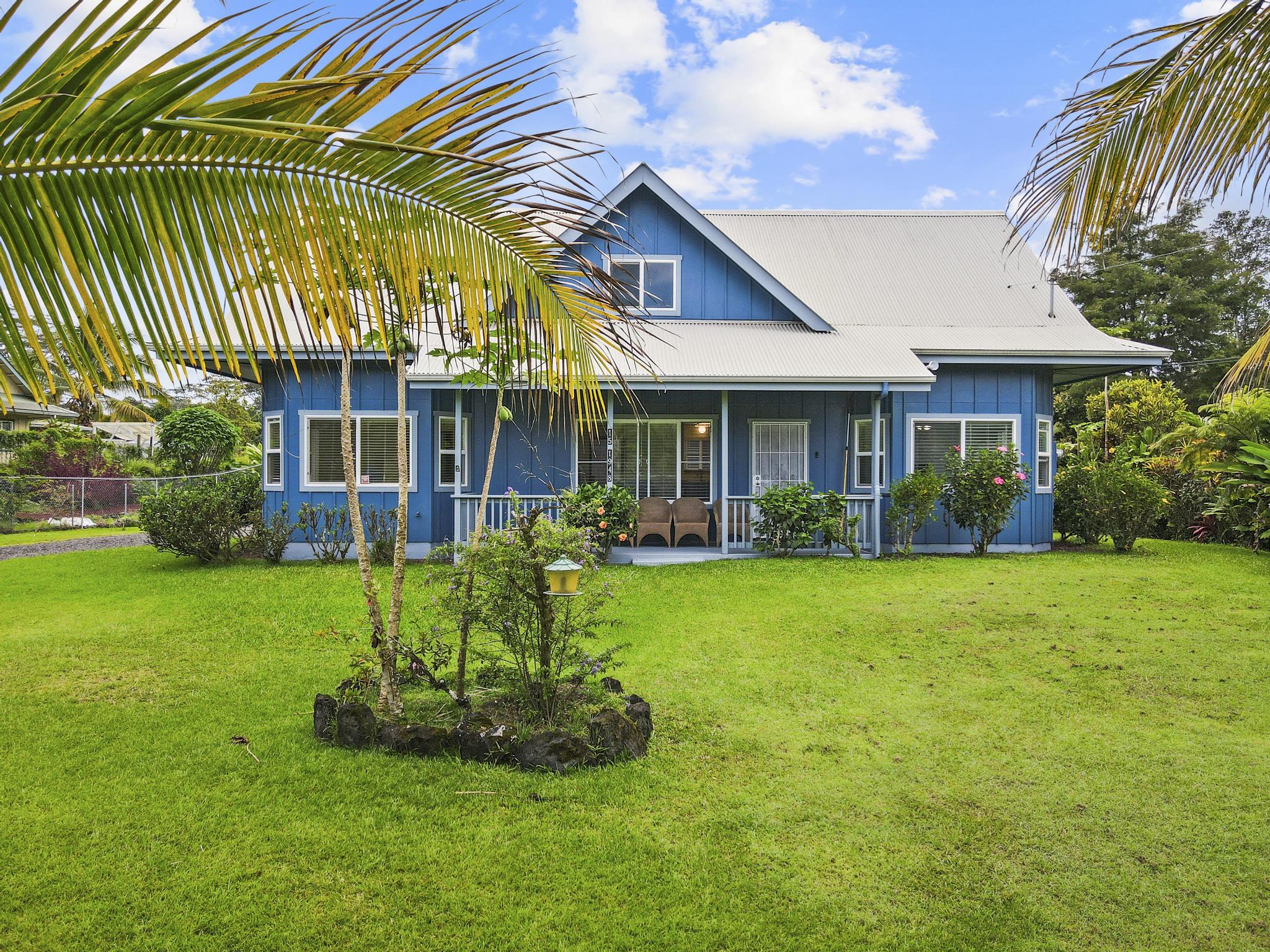 a view of a house with a backyard and a patio