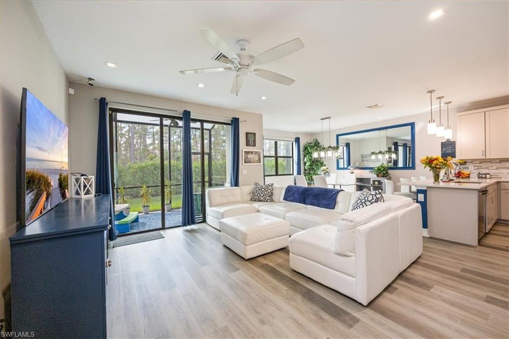 a living room with furniture and large windows