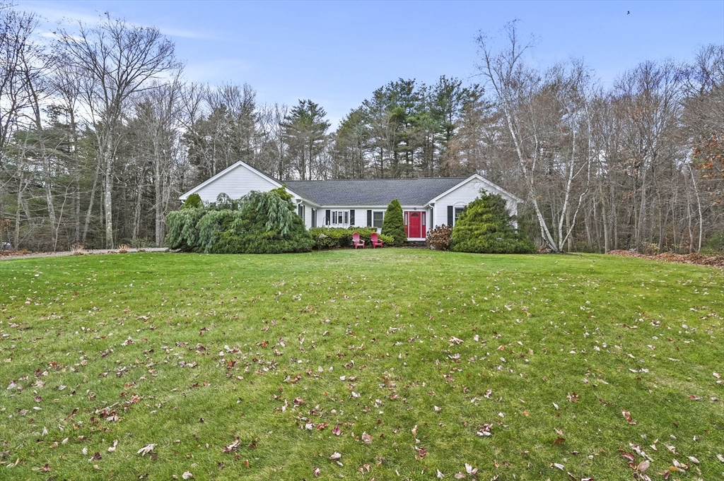 a view of a green field in front of the house