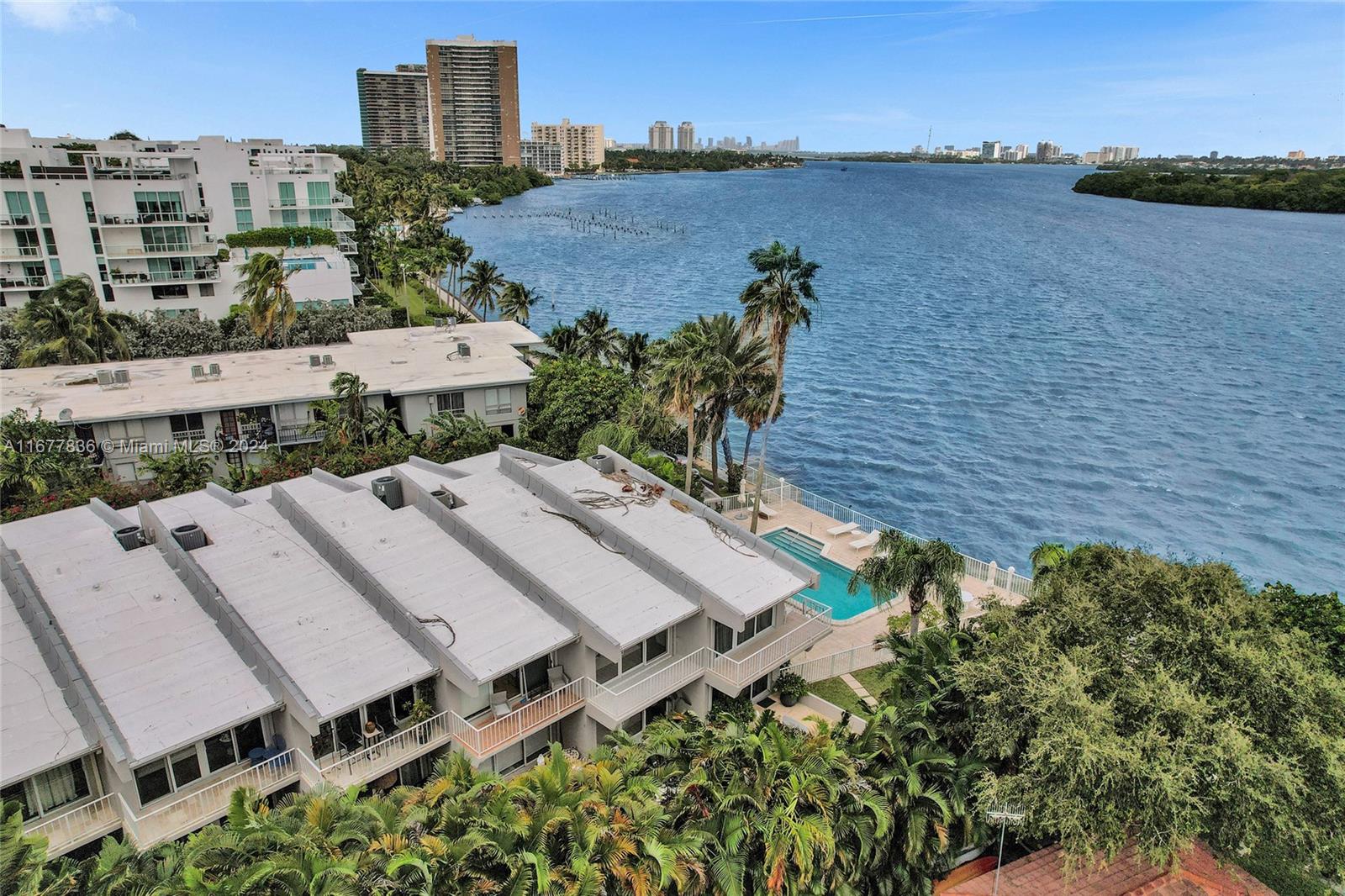 an aerial view of a house with a yard and lake view