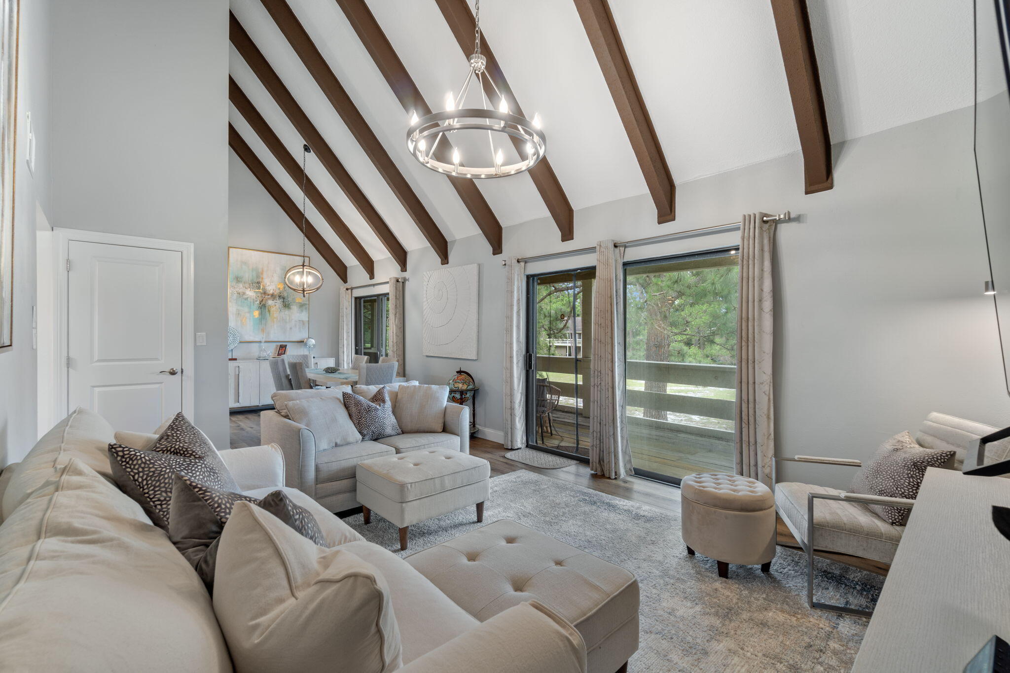 a living room with furniture and a floor to ceiling window