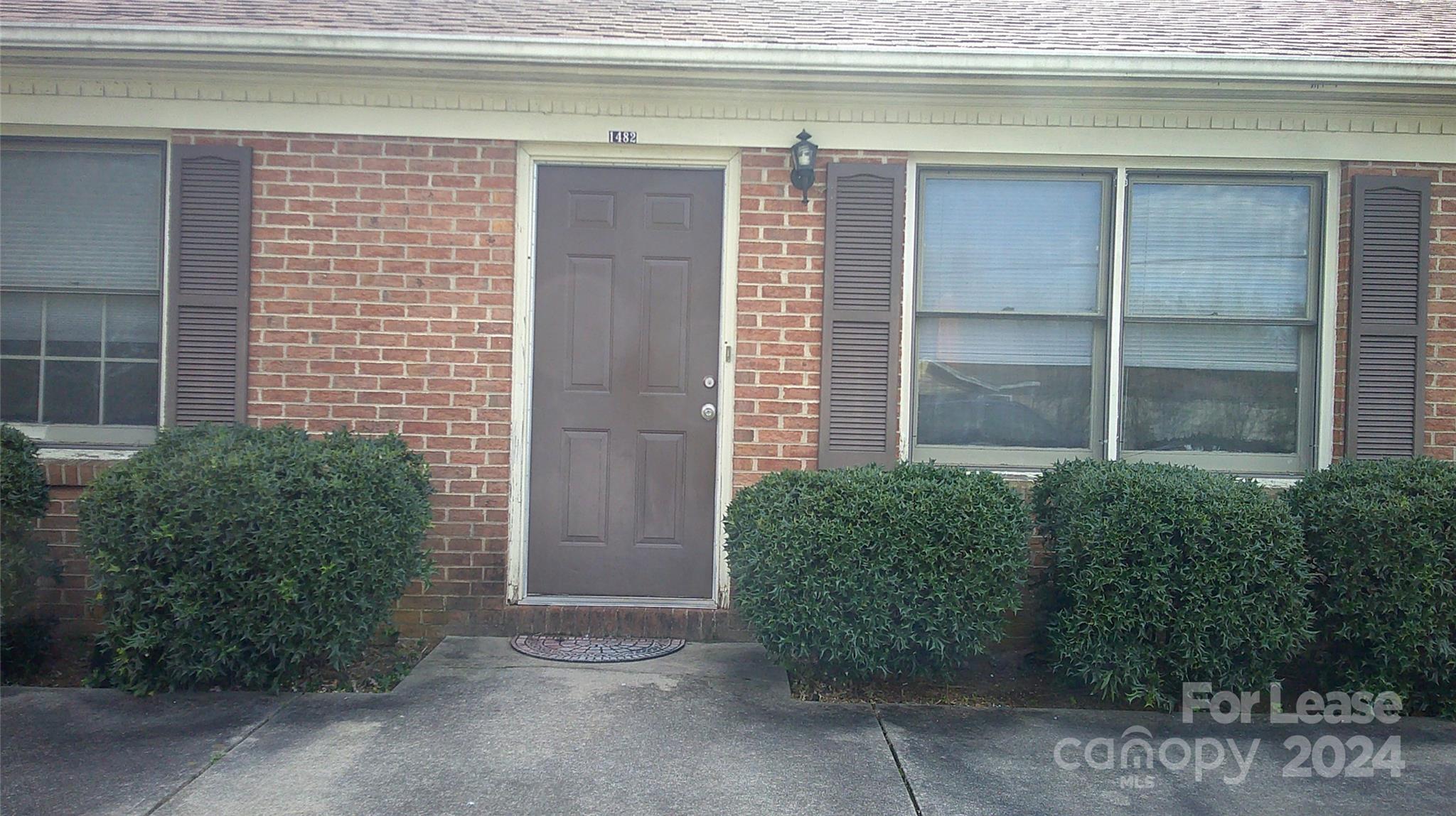 a couple of potted plants in front of door