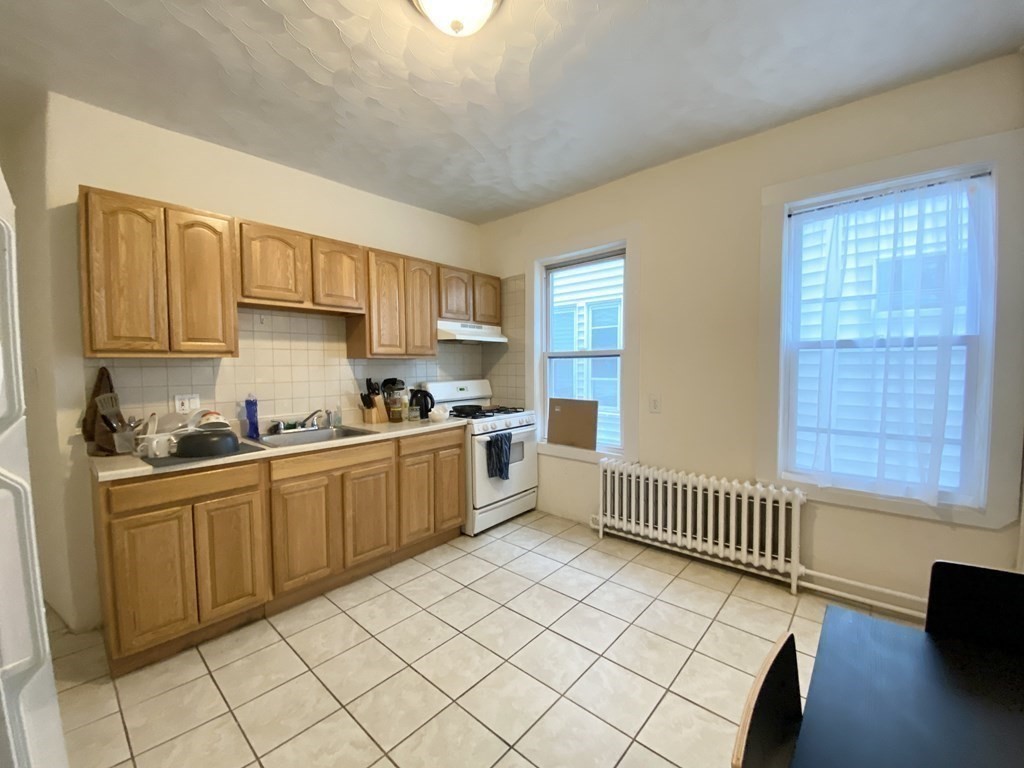 a kitchen with a sink cabinets and window