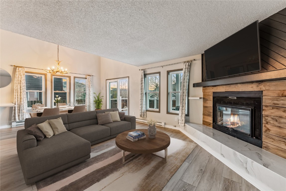 a living room with furniture a flat screen tv and a fireplace