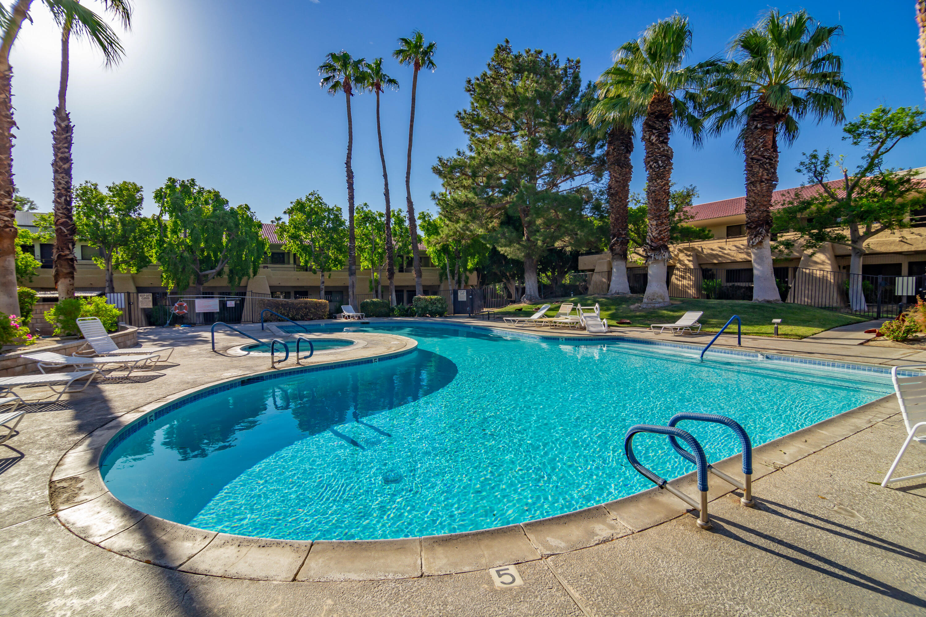 a swimming pool with outdoor seating and yard