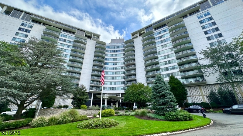 a view of a building with a yard and plants