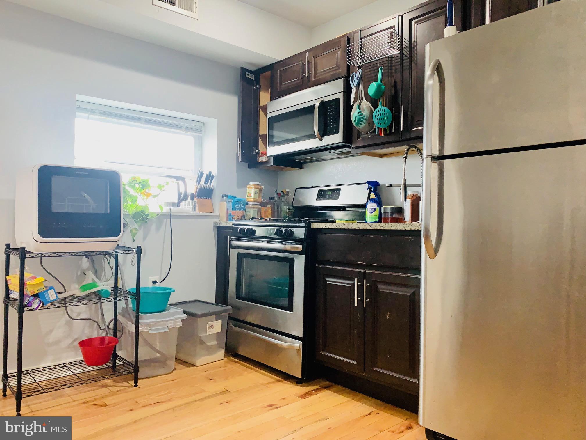 a kitchen with a refrigerator stove and microwave