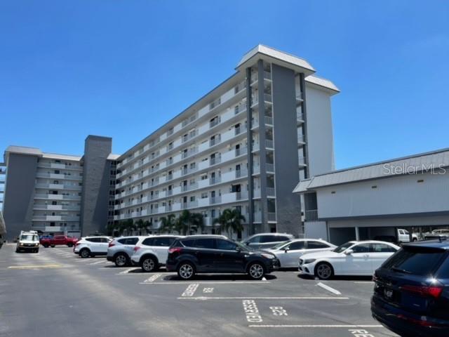 a view of parking with cars parked in front of it