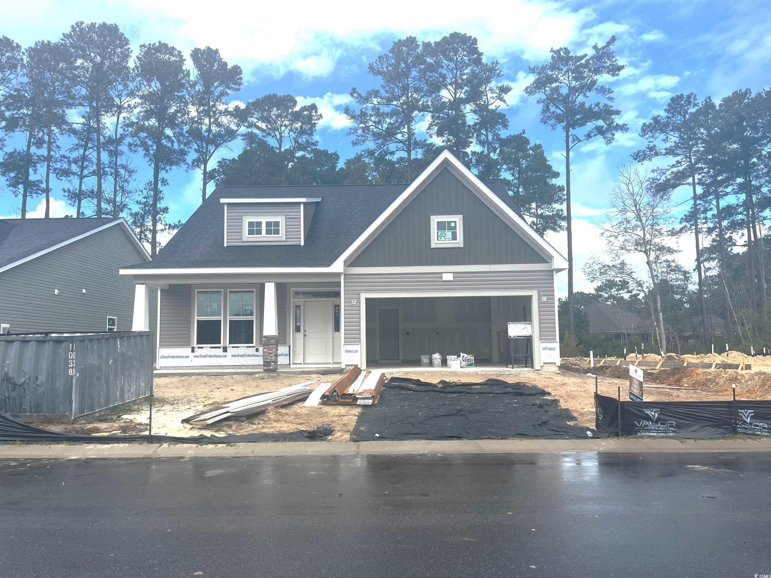 View of front facade featuring a garage and covere