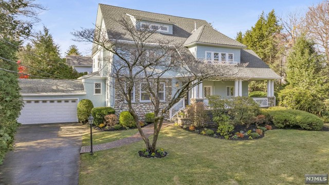 a house that has a tree in front of it