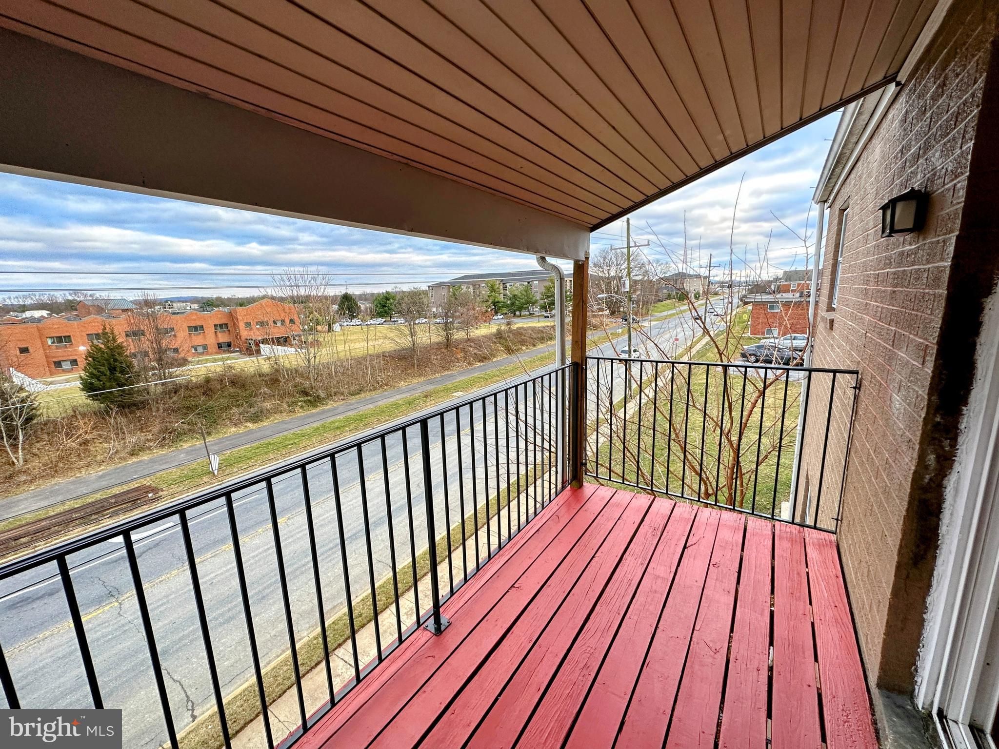 a view of balcony with wooden floor