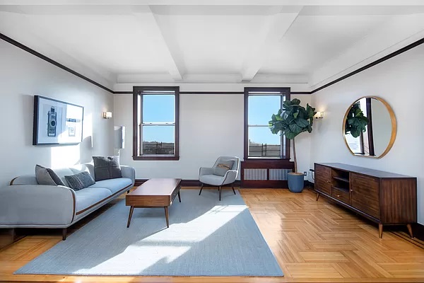 a living room with furniture and a mirror